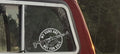 Car window with a decal reading 'My Guns Are Not For Sale' against a natural background.